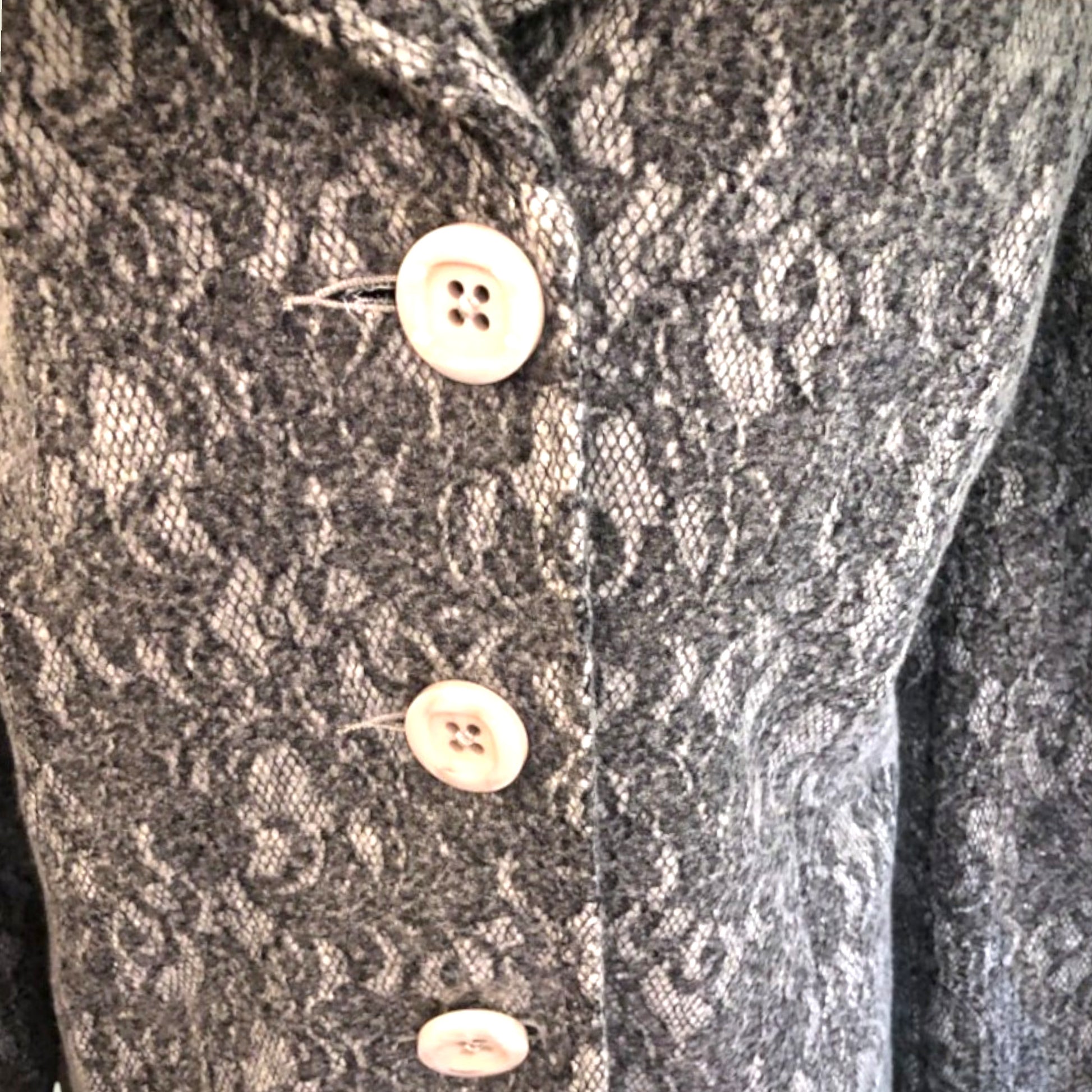 Close-up of a textured fabric with buttons on a garment