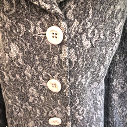 Close-up of a textured fabric with buttons on a garment
