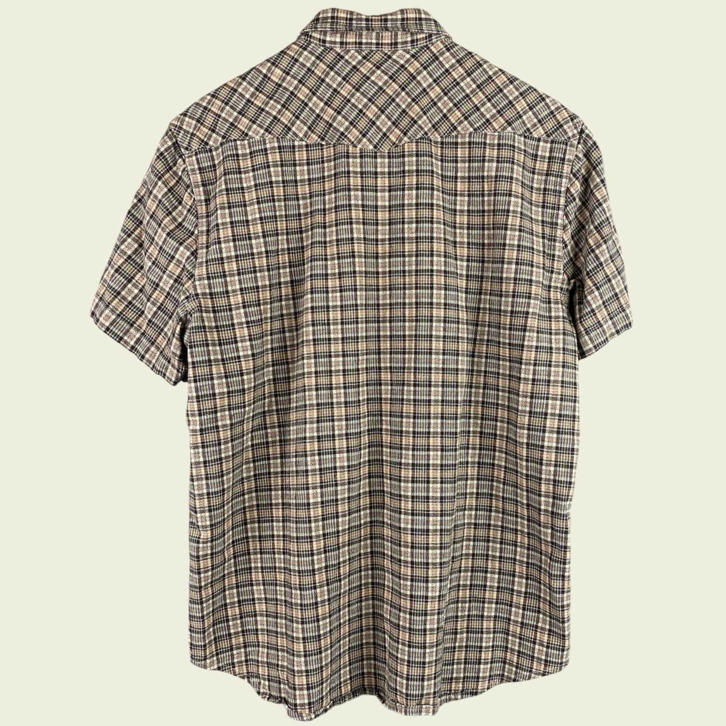 Plaid short-sleeve shirt on a beige background