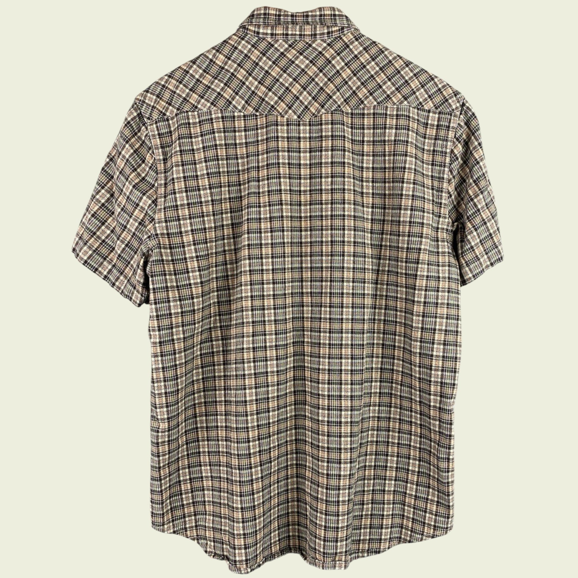 Plaid short-sleeve shirt on a beige background