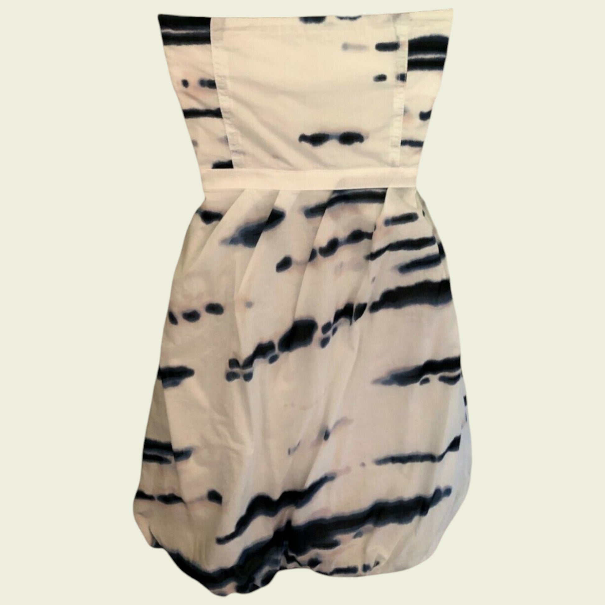Beige strapless dress with black abstract pattern on a beige background