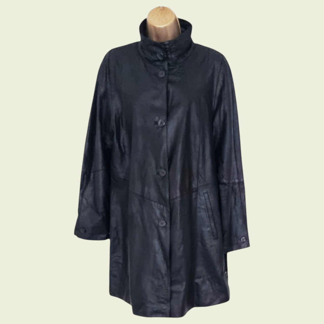 Black raincoat on a mannequin against a beige background