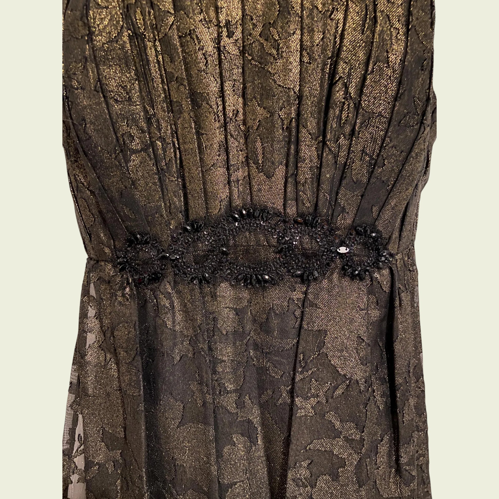 Brown floral lace dress with a decorative belt on a beige background