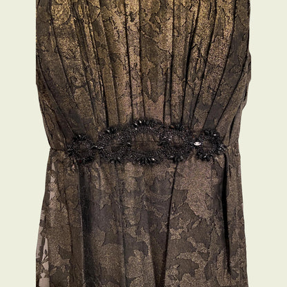 Brown floral lace dress with a decorative belt on a beige background