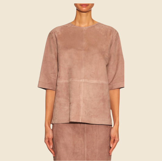 Brown suede top worn by a model on a beige background