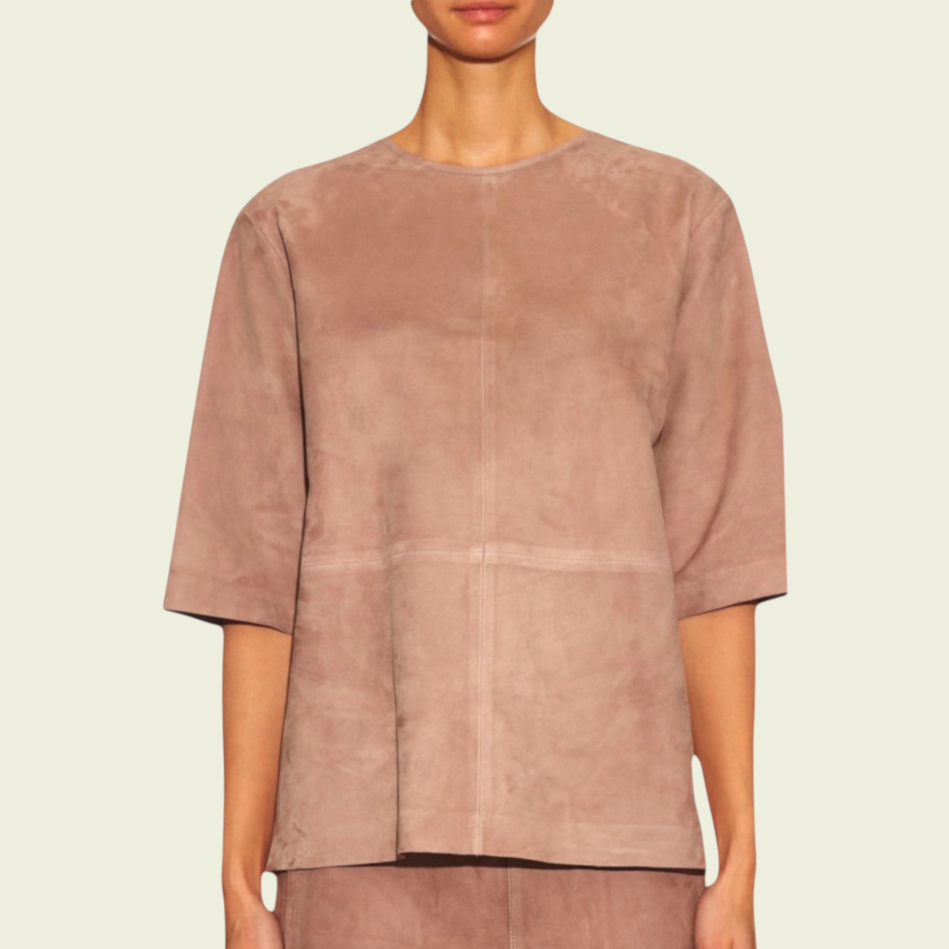 Tan suede top worn by a model on a beige background