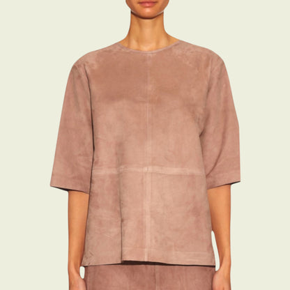 Tan suede top worn by a model on a beige background