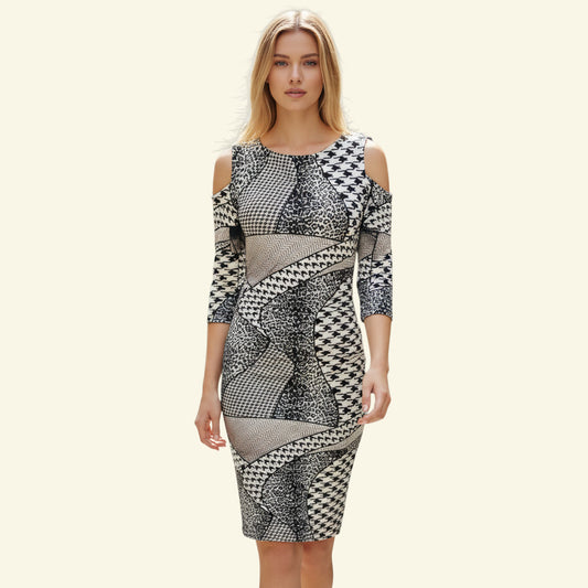 Joseph Ribkoff black and white patchwork print cold shoulder dress with half sleeves and concealed back zip. Polyester blend.