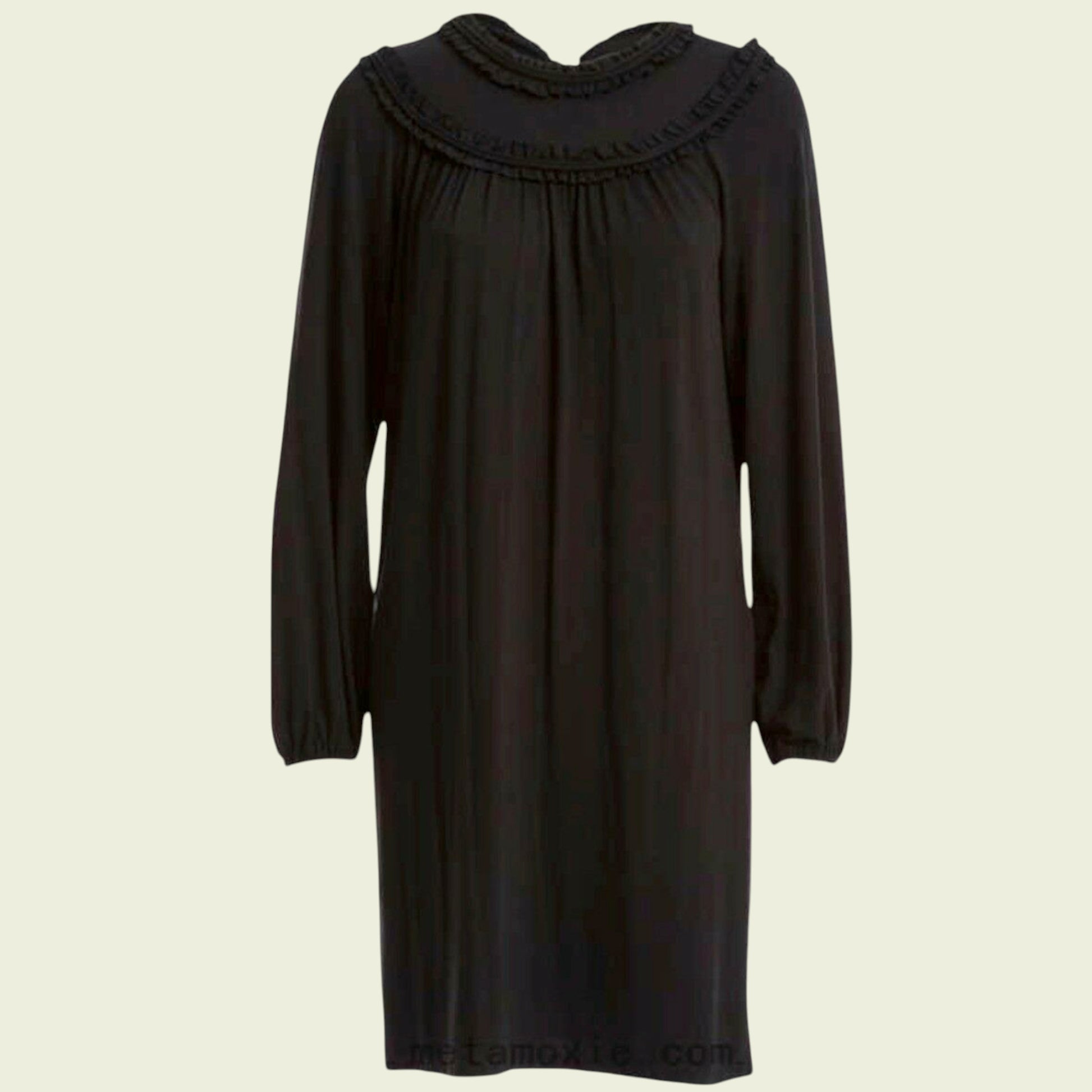 Black dress with a ruffled neckline on a beige background