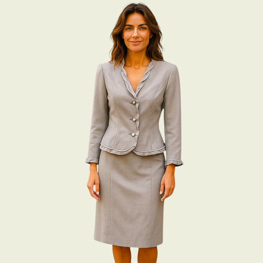 Model wearing grey silk skirt and jacket on beige background