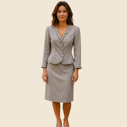 Woman wearing a gray suit on a beige background
