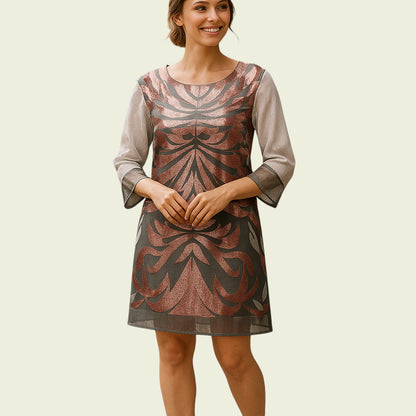 Woman wearing a patterned dress on a beige background