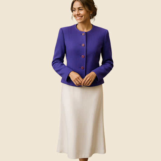 Woman wearing a purple jacket and white skirt on a beige background