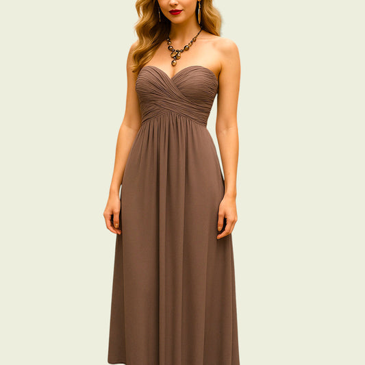 Woman wearing a strapless brown dress against a plain background