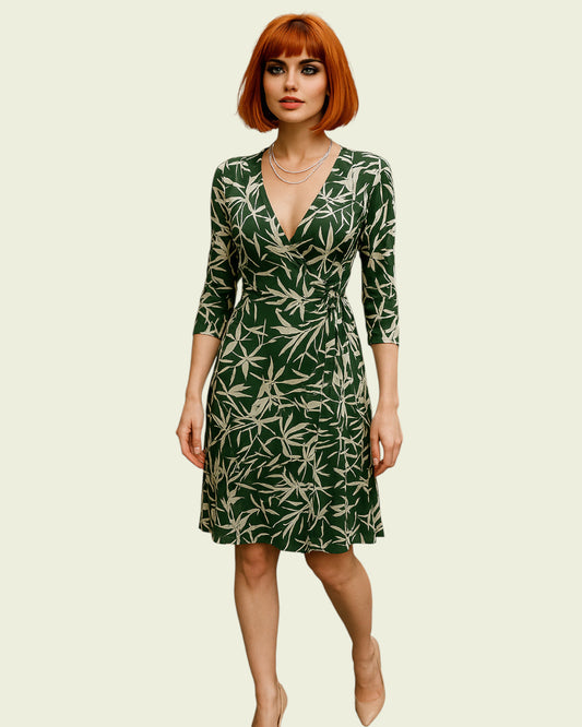 Woman wearing a green dress with leaf pattern on a beige background