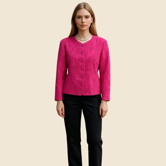 Woman wearing a pink jacket and black pants on a beige background