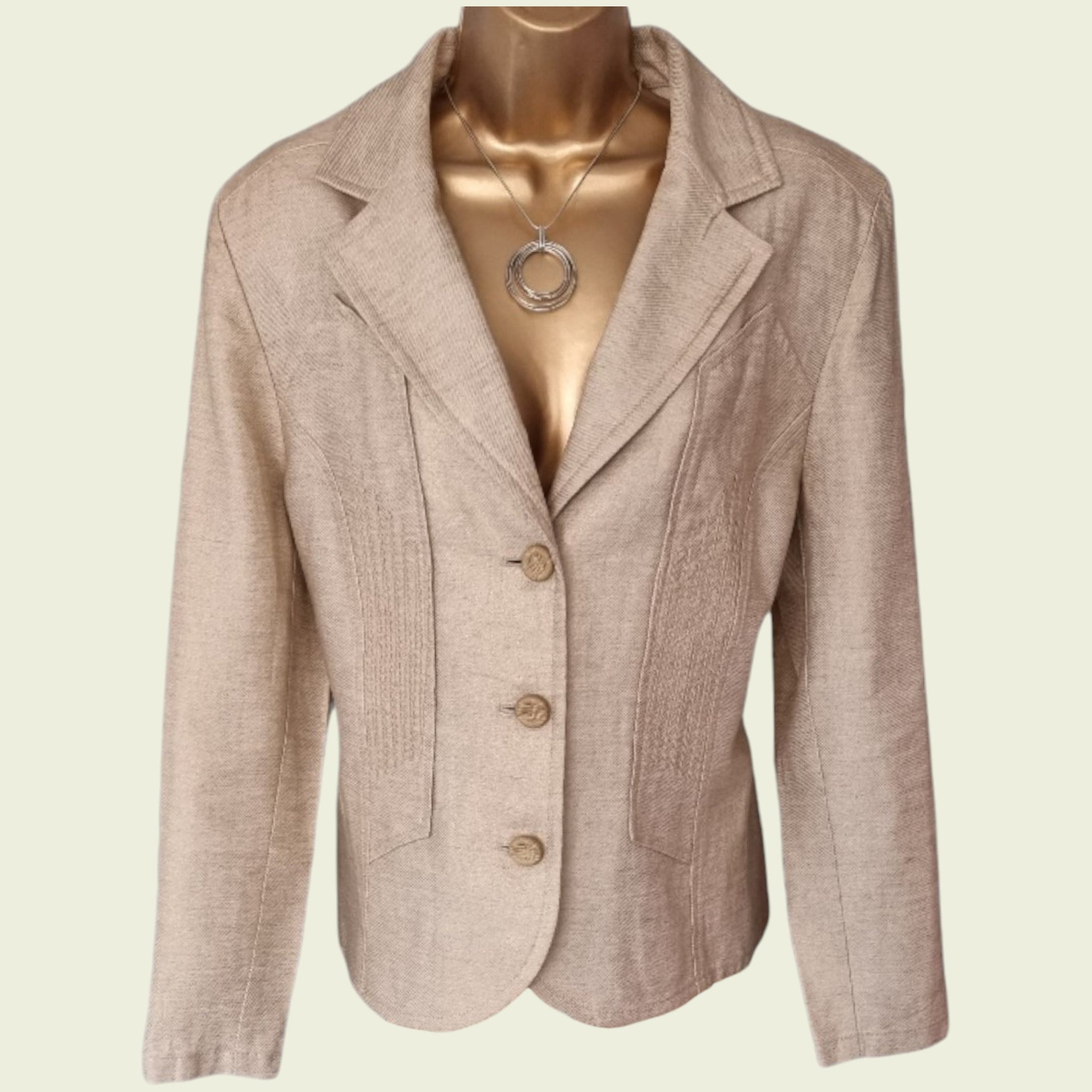 Beige blazer on a mannequin with a plain background