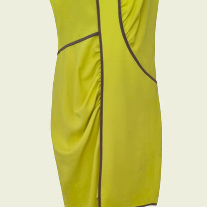 Yellow dress with brown piping on a beige background