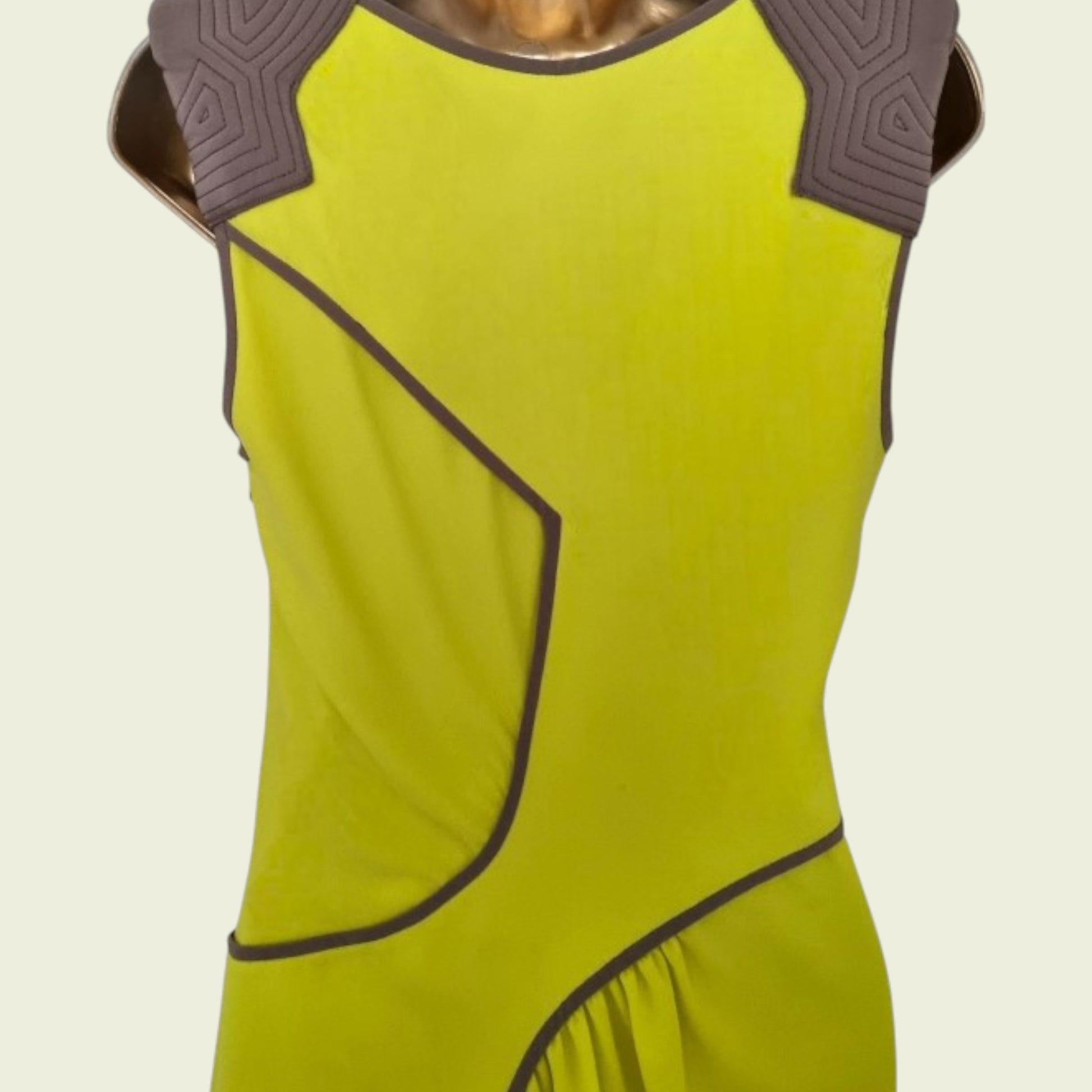 Yellow dress with brown accents on a beige background