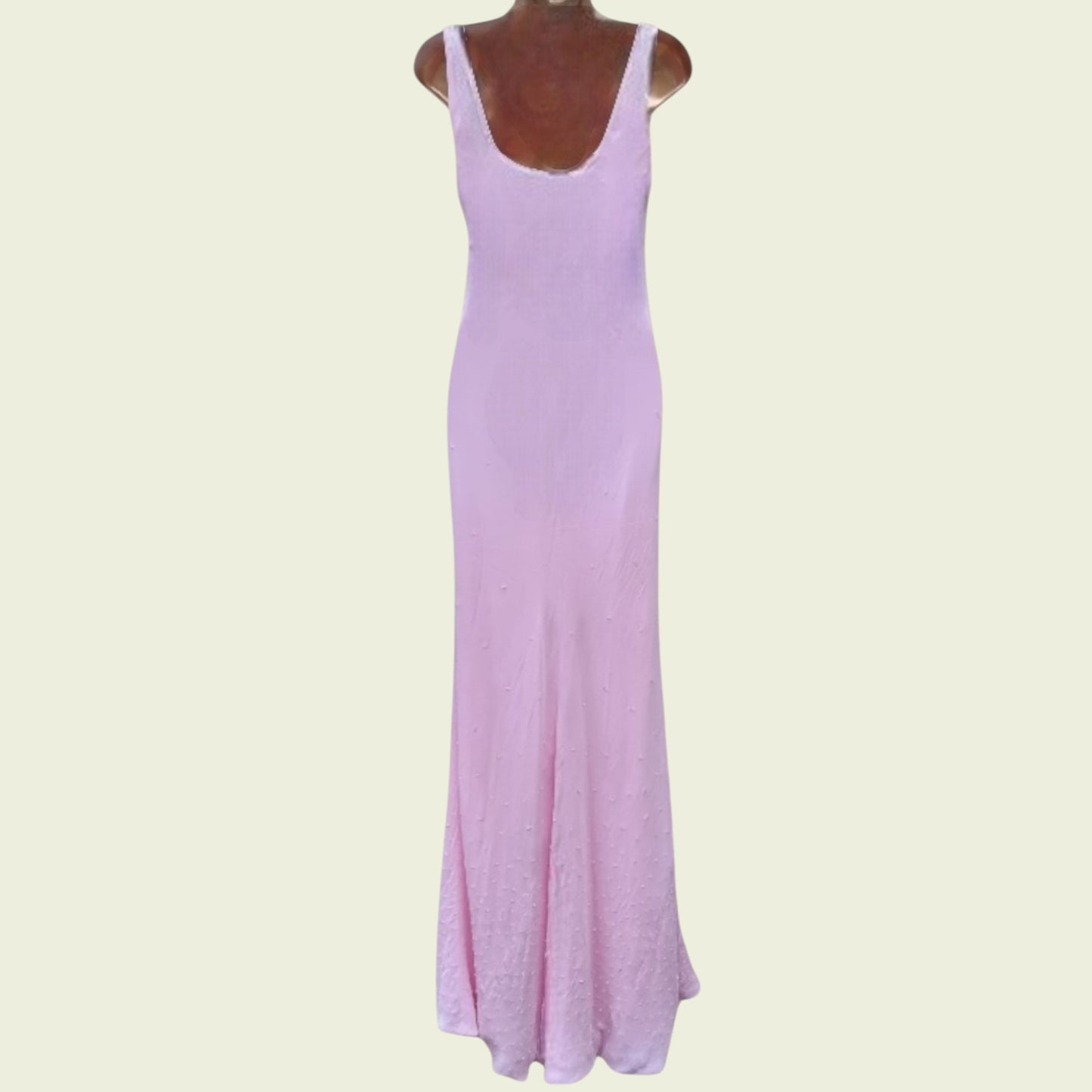 Pink dress on a mannequin against a light beige background