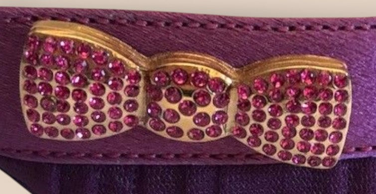 Purple belt with a gold bow accent featuring pink rhinestones on a white background