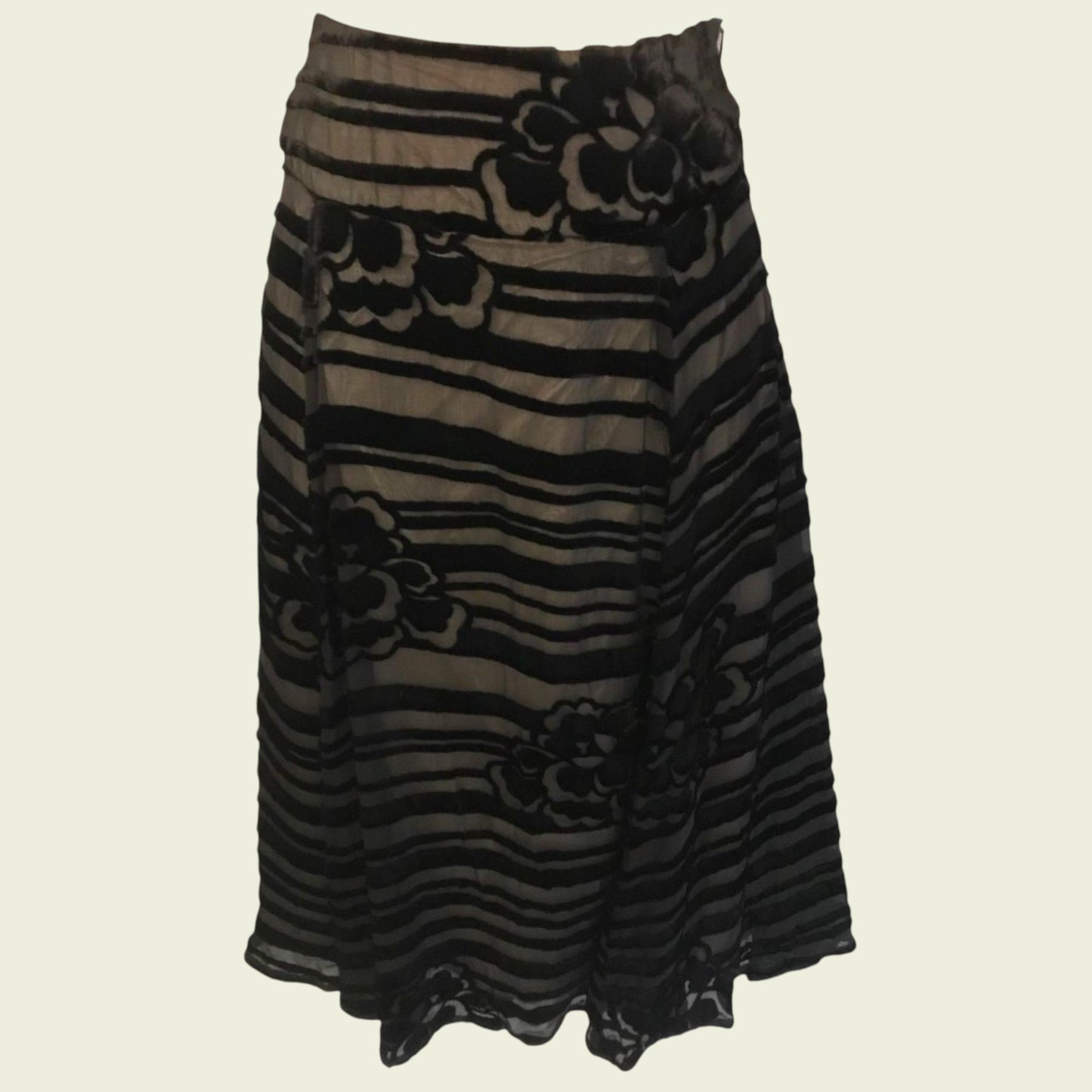 Black and brown striped skirt with floral patterns on a beige background