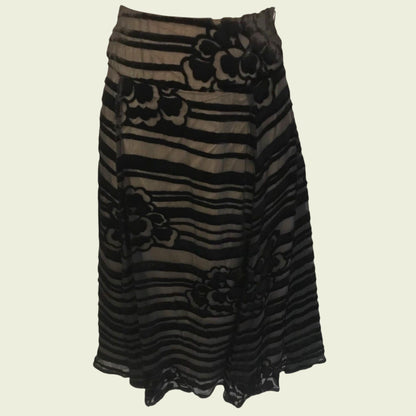 Black and brown striped skirt with floral patterns on a beige background
