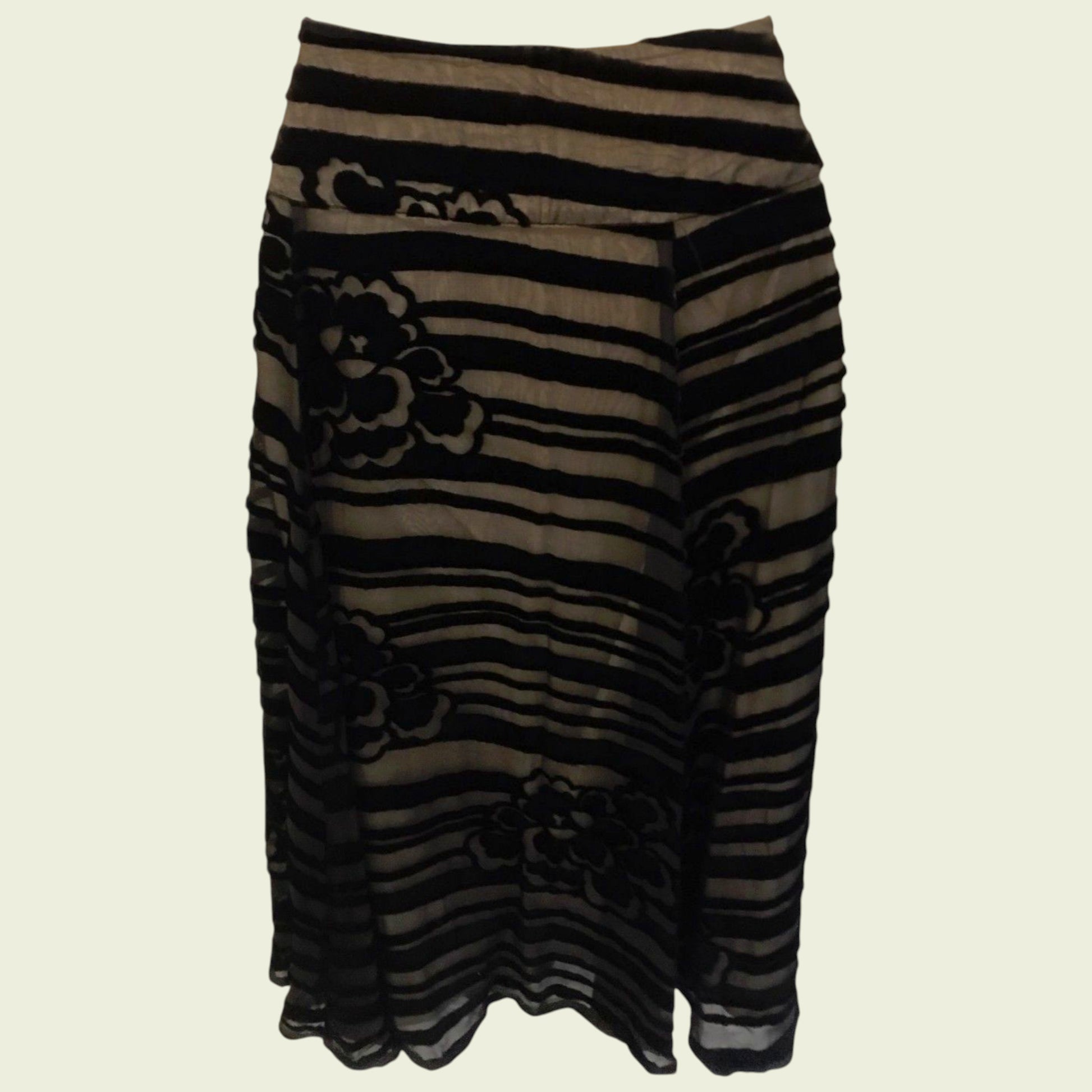 Black and brown striped skirt with floral patterns on a beige background