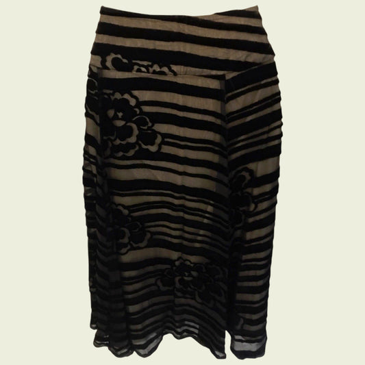 Black and brown striped skirt with floral patterns on a beige background