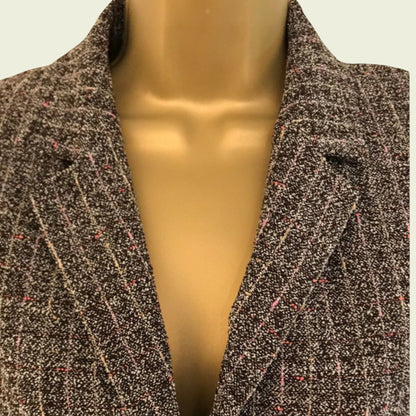 Mannequin wearing a coat with a neutral background