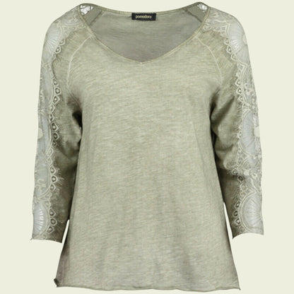 Light green long-sleeve top with lace detailing on a beige background