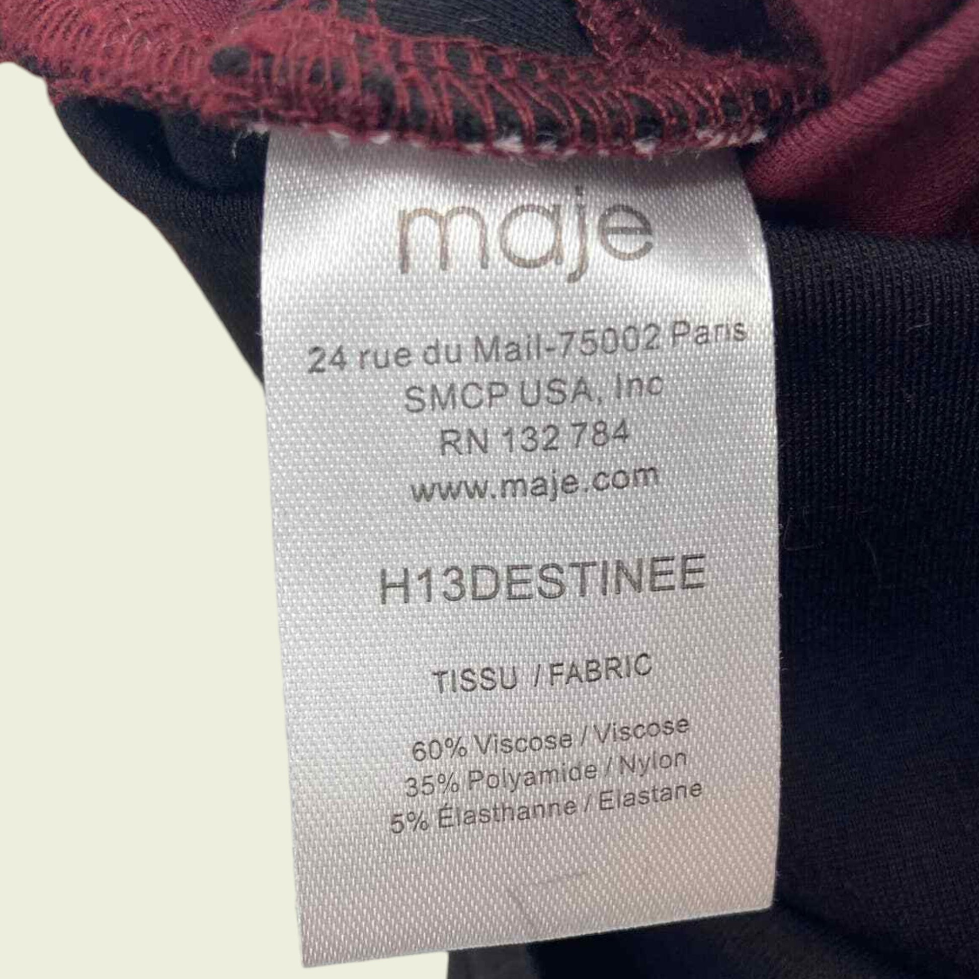Maje clothing label with brand name and product details on a neutral background