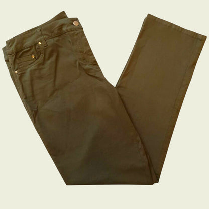 Folded khaki jeans on beige background