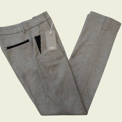 Gray patterned pants with a tag on a beige background