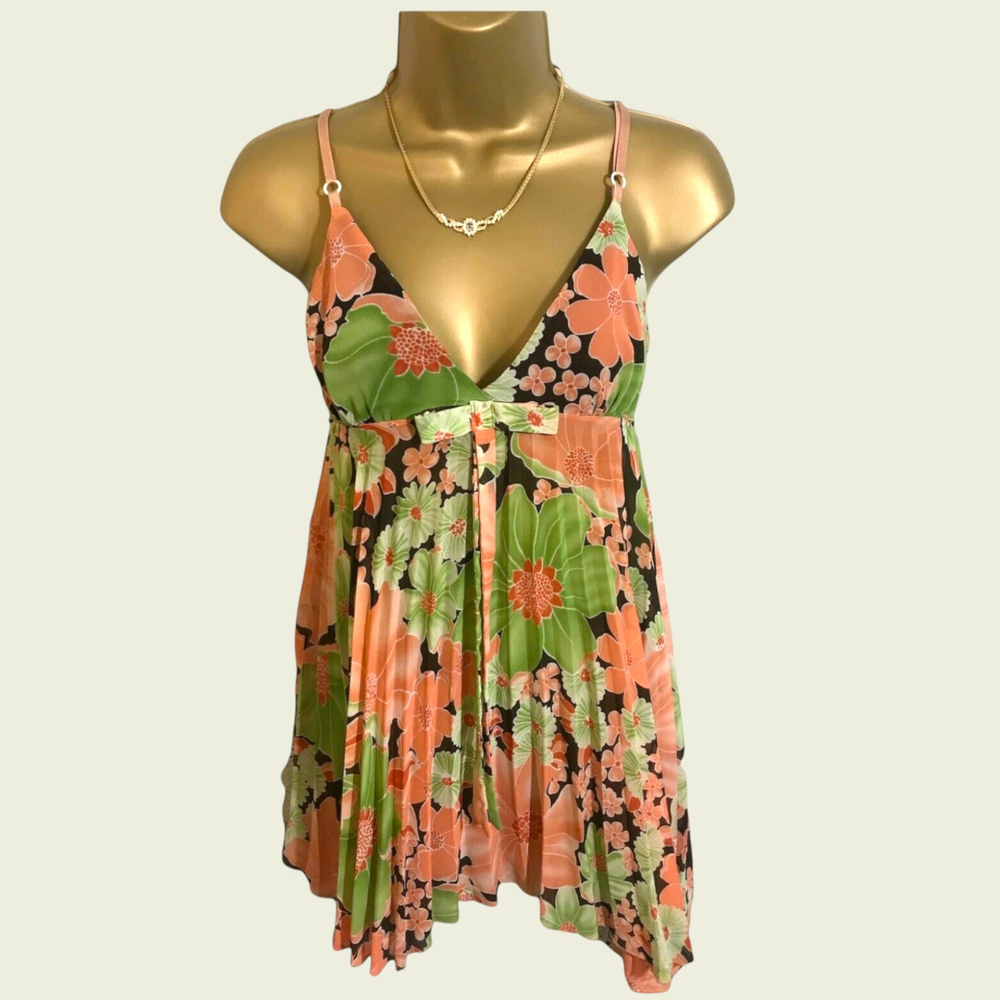 Floral top on a mannequin against a plain background
