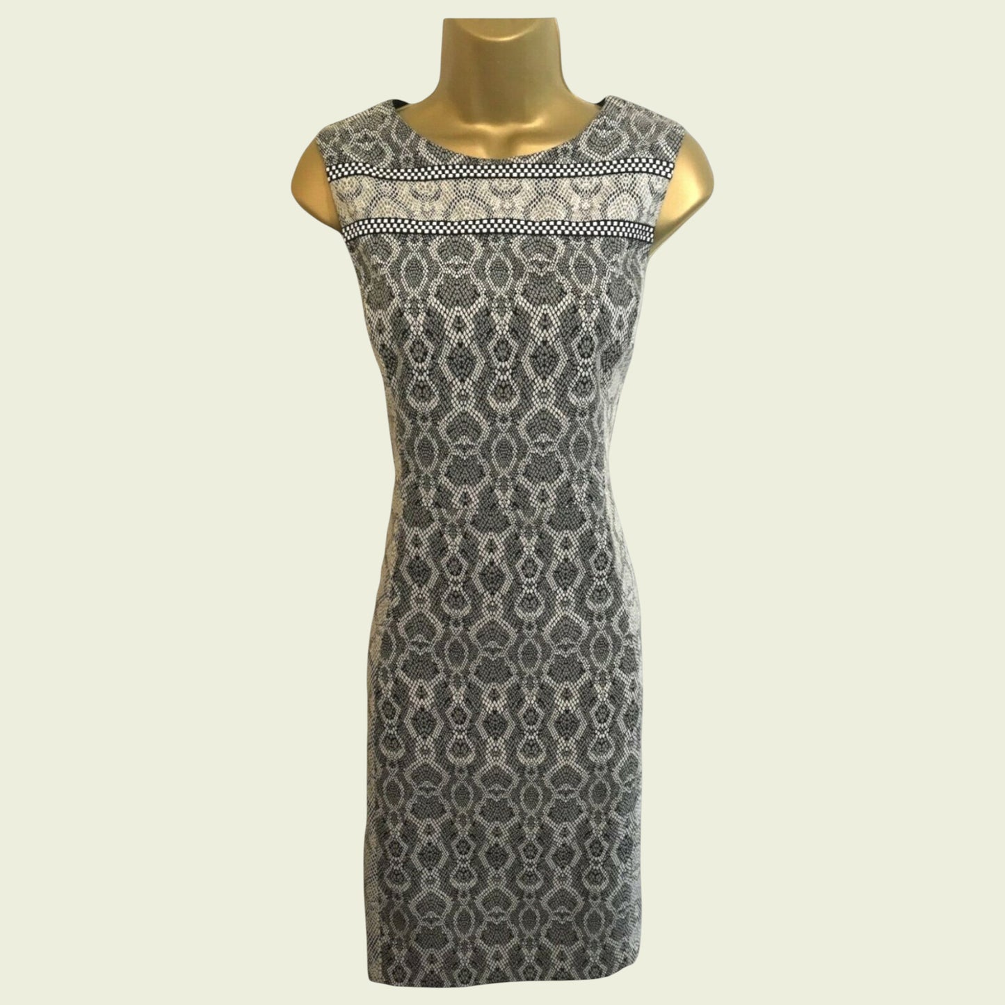 Patterned dress on a mannequin against a plain background