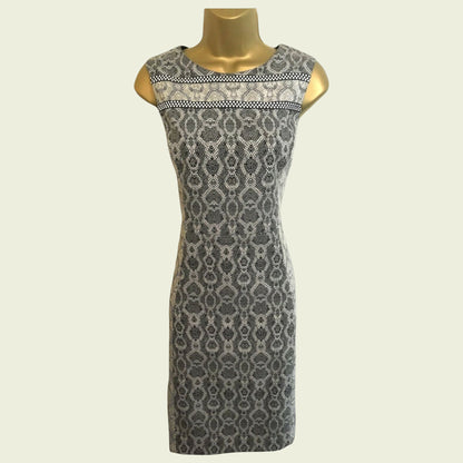 Patterned dress on a mannequin against a plain background