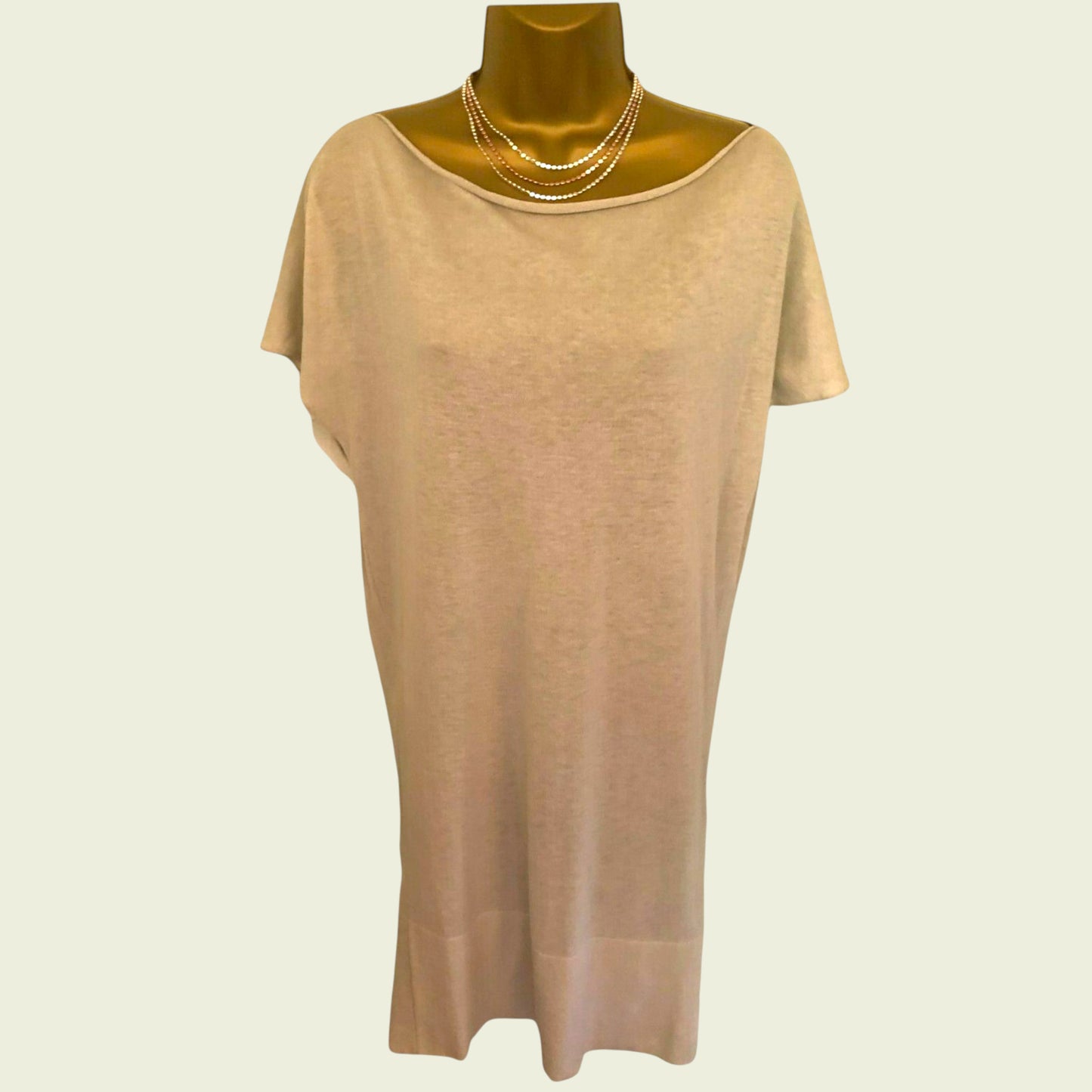 Beige dress on a mannequin with a plain background