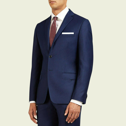 Navy blue suit with a white shirt and patterned tie on a beige background