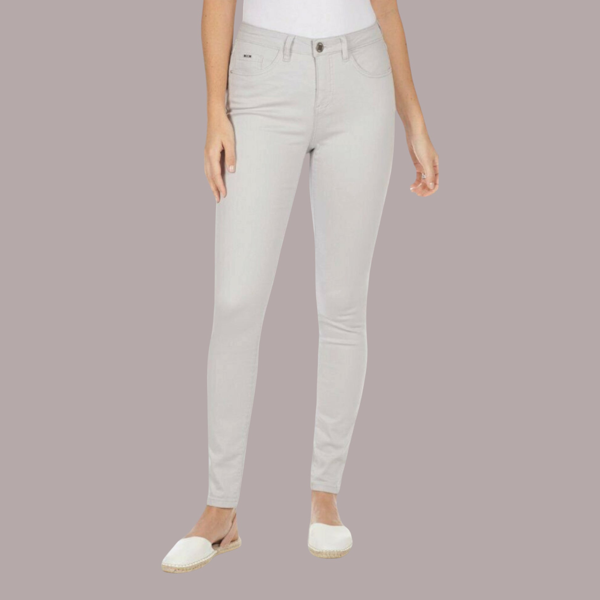 Light gray jeans worn by a person on a plain background