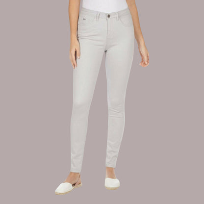 Light gray jeans worn by a person on a plain background