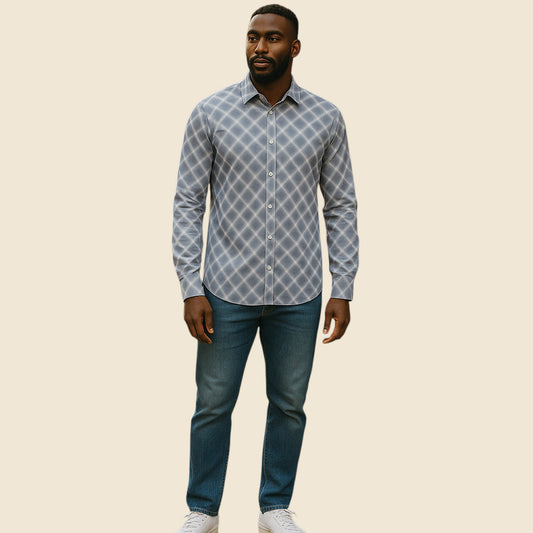 Man wearing a patterned shirt and jeans on a beige background