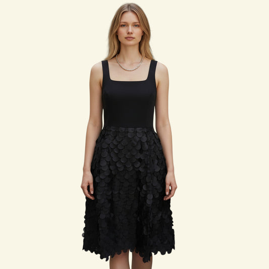 Timelessfashions black fit & flare dress with square neckline and disc detail skirt. Viscose/Polyester.