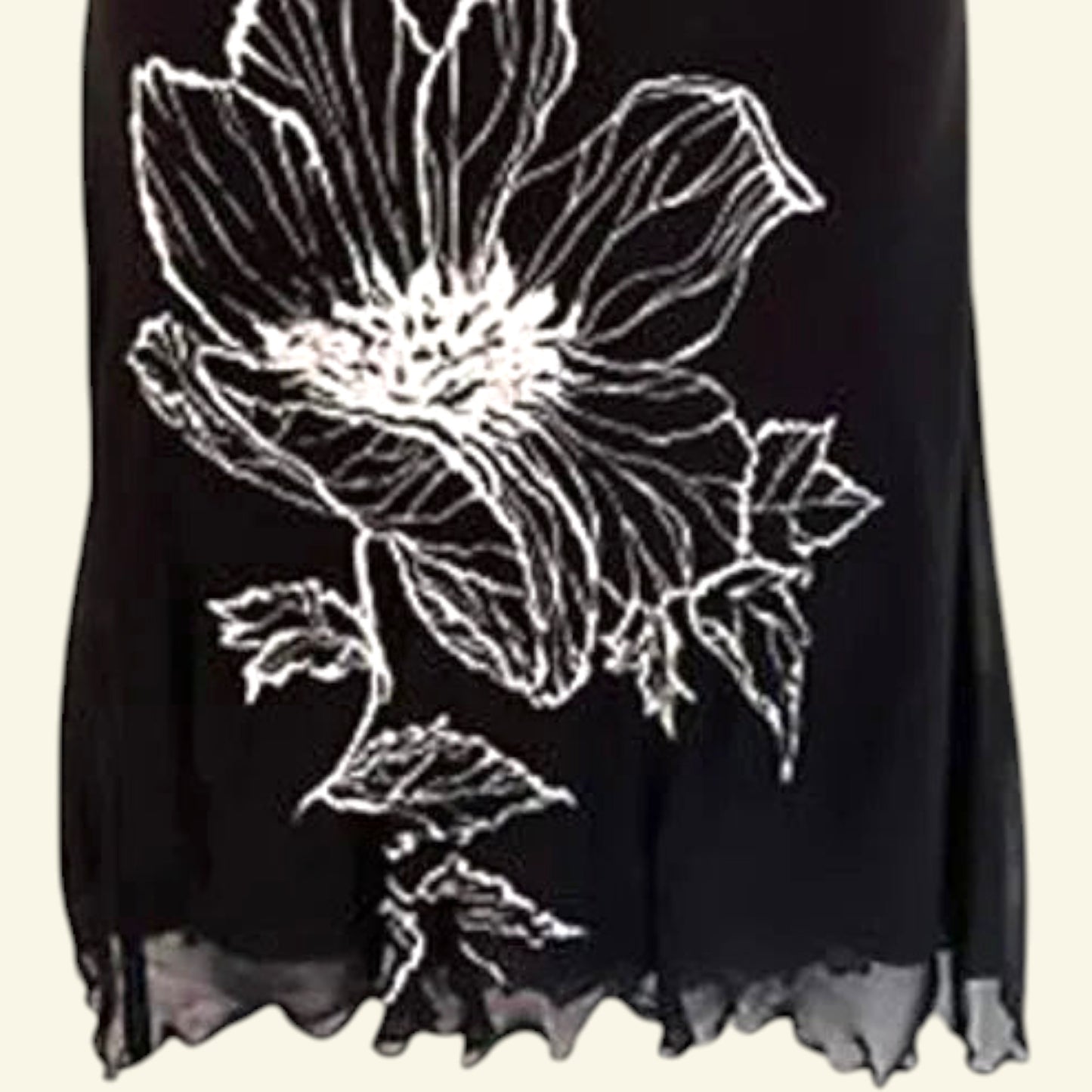 Timelessfashions black chiffon midi skirt with white floral print and scalloped hem. Side zip closure.
