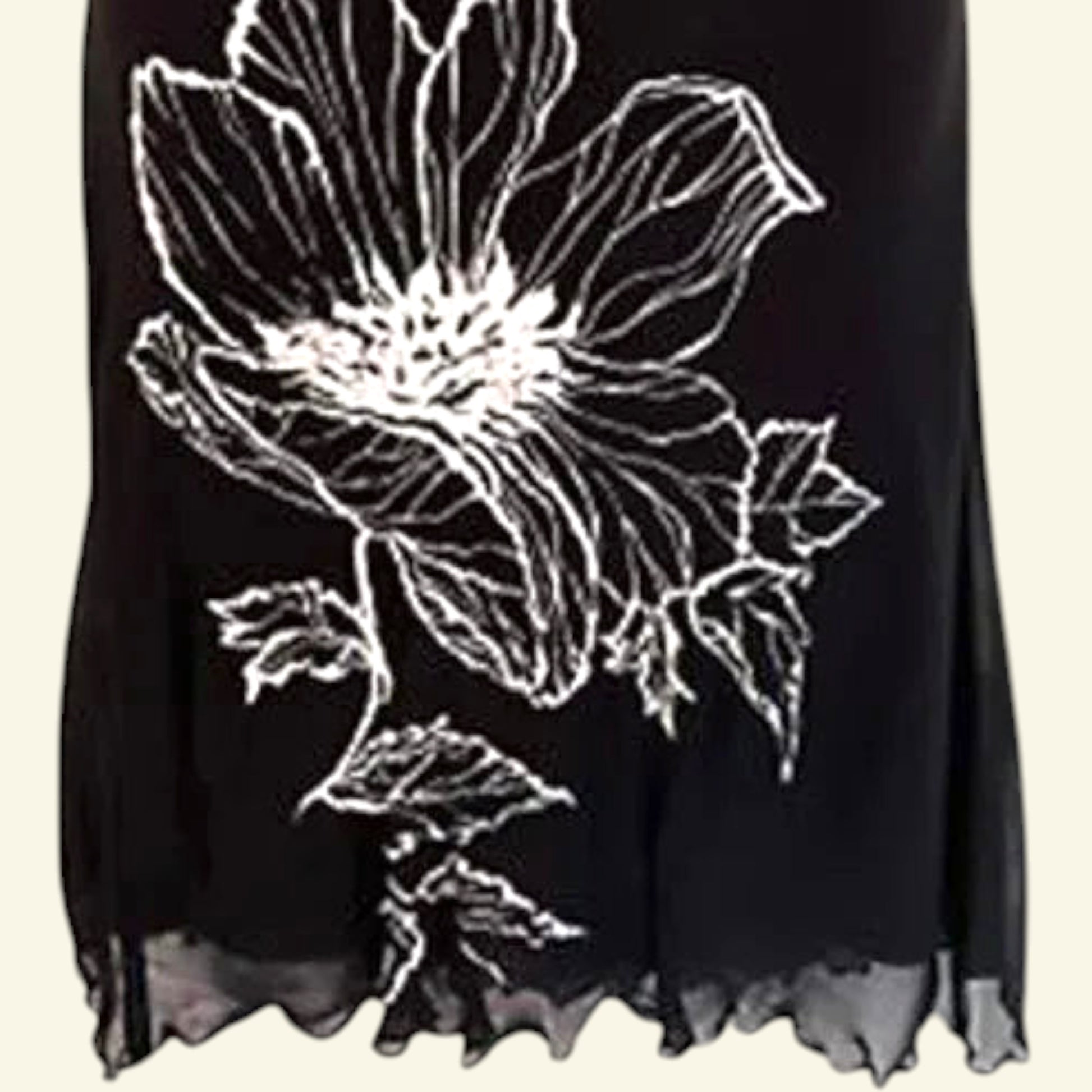 Timelessfashions black chiffon midi skirt with white floral print and scalloped hem. Side zip closure.