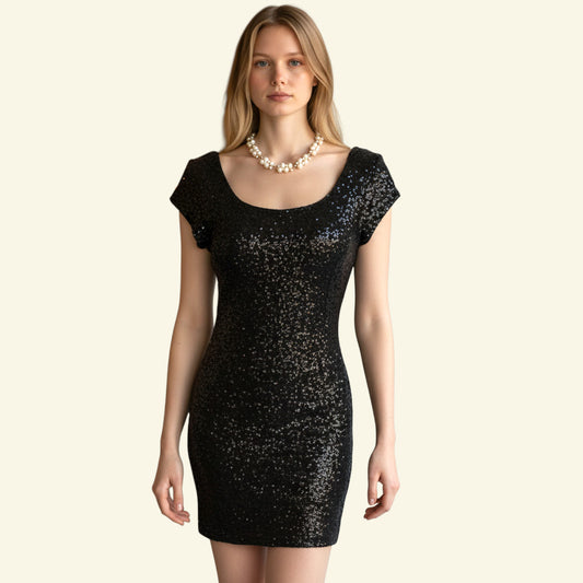 Timelessfashions black sequin mini dress with short sleeves and scoop neck. Polyester fabric.