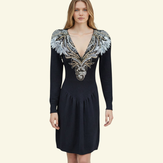 Timelessfashions 1960s black wool blend sweater dress with V-neck, sequin and bead embellishments, and mini shoulder pads.