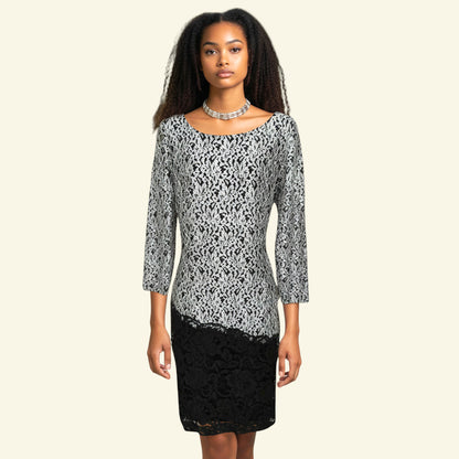 Timelessfashions black and silver lace overlay midi dress with three-quarter sleeves and a kick split. Polyester, nylon, spandex blend.