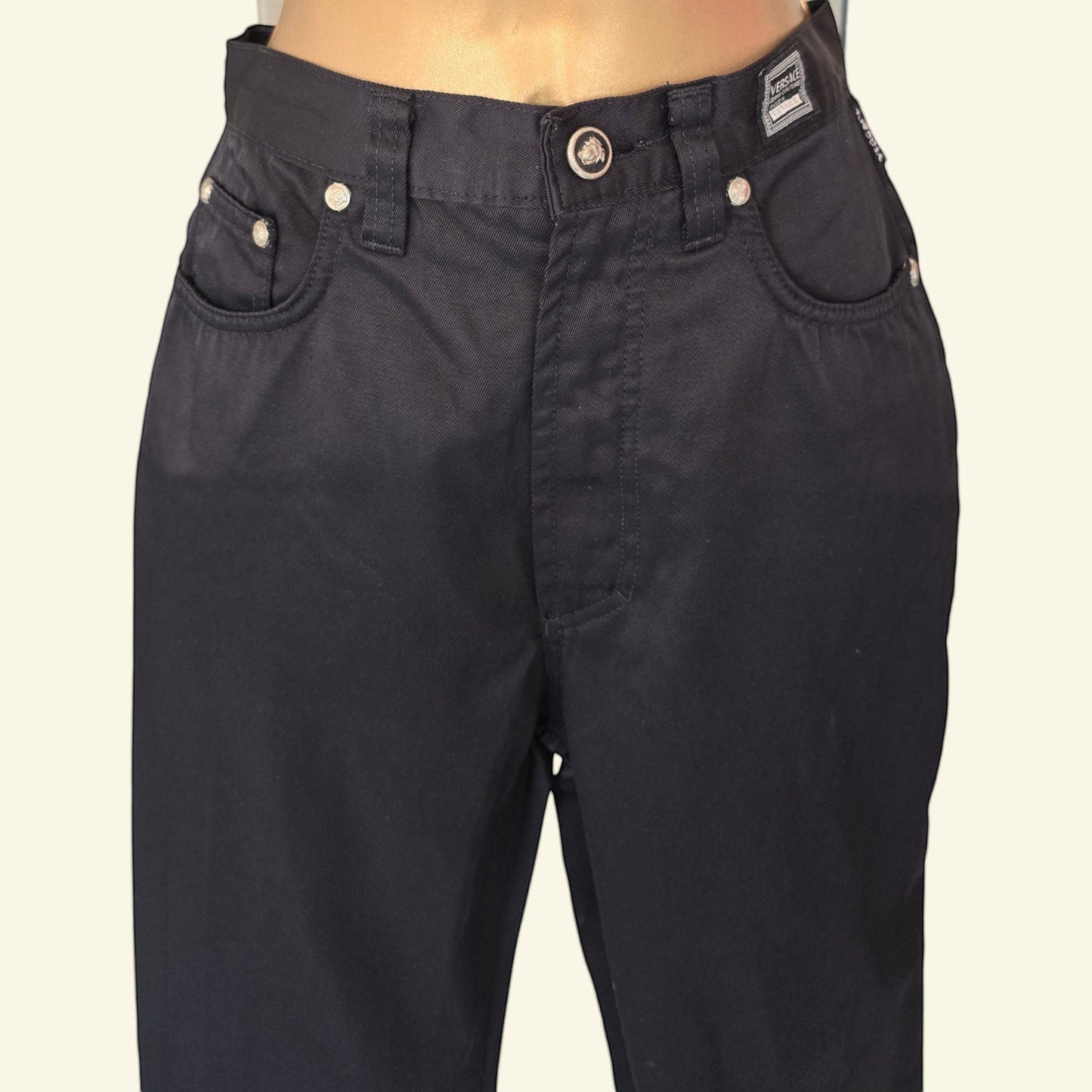 Timelessfashions Versace womens black skinny cotton jeans with silver button details and iconic Medusa head emblem.