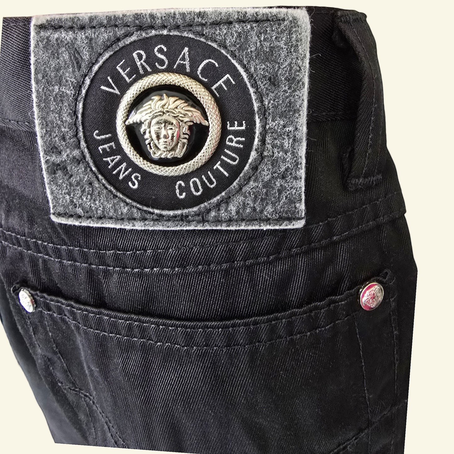 Timelessfashions Versace black cotton skinny jeans with Medusa logo patch and silver button details.